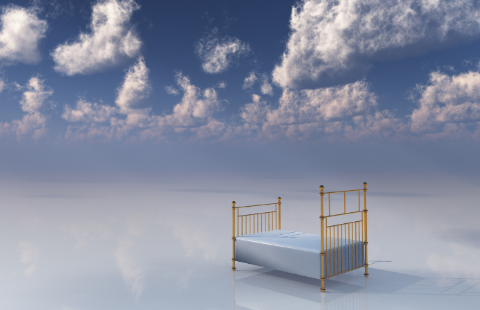 Brass bed in the cloudy sky